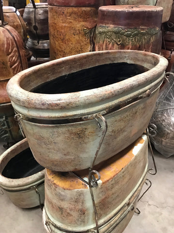 Large clay boat style pot with iron
